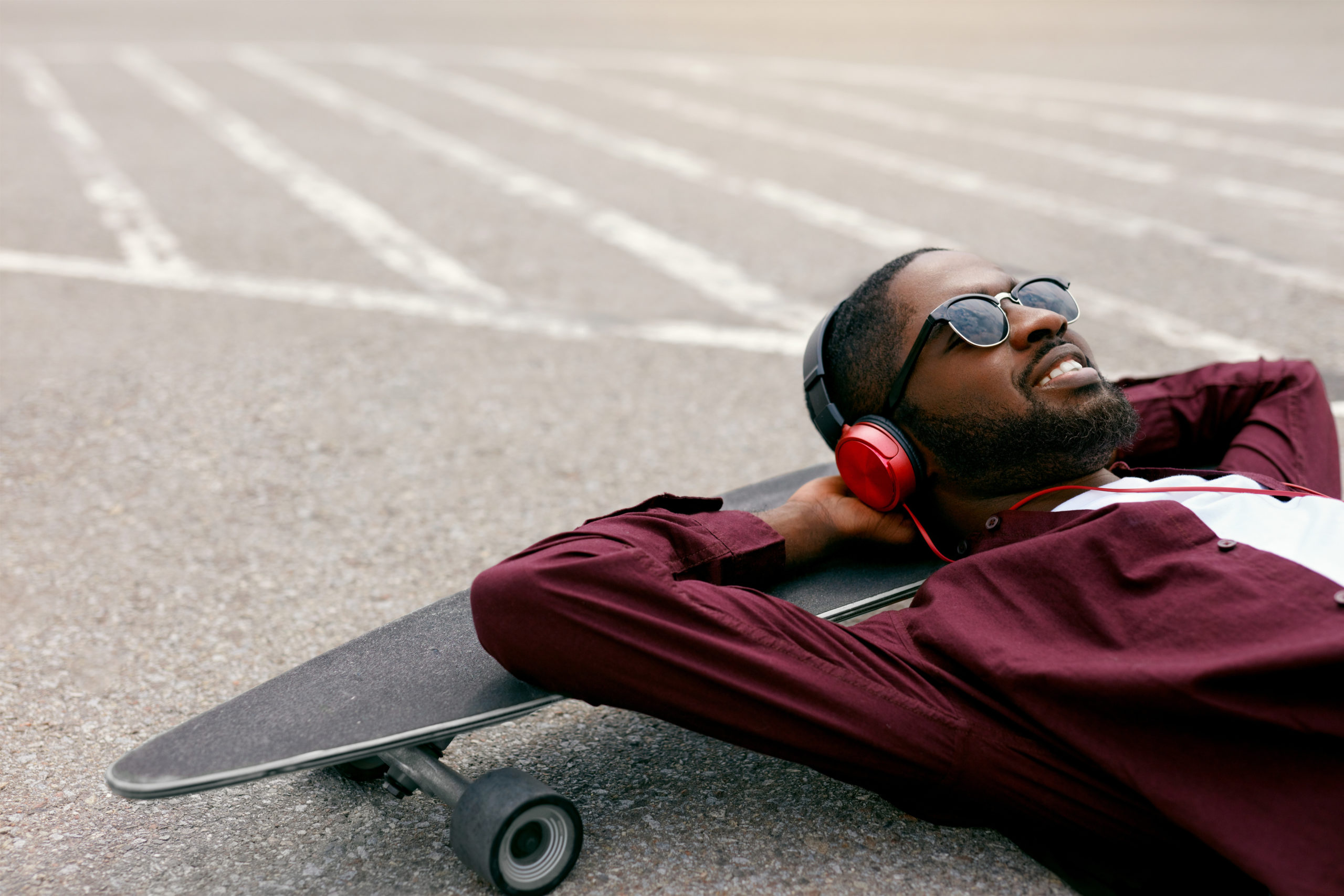Fashion. Black Man Listening Music In Headphones On Street